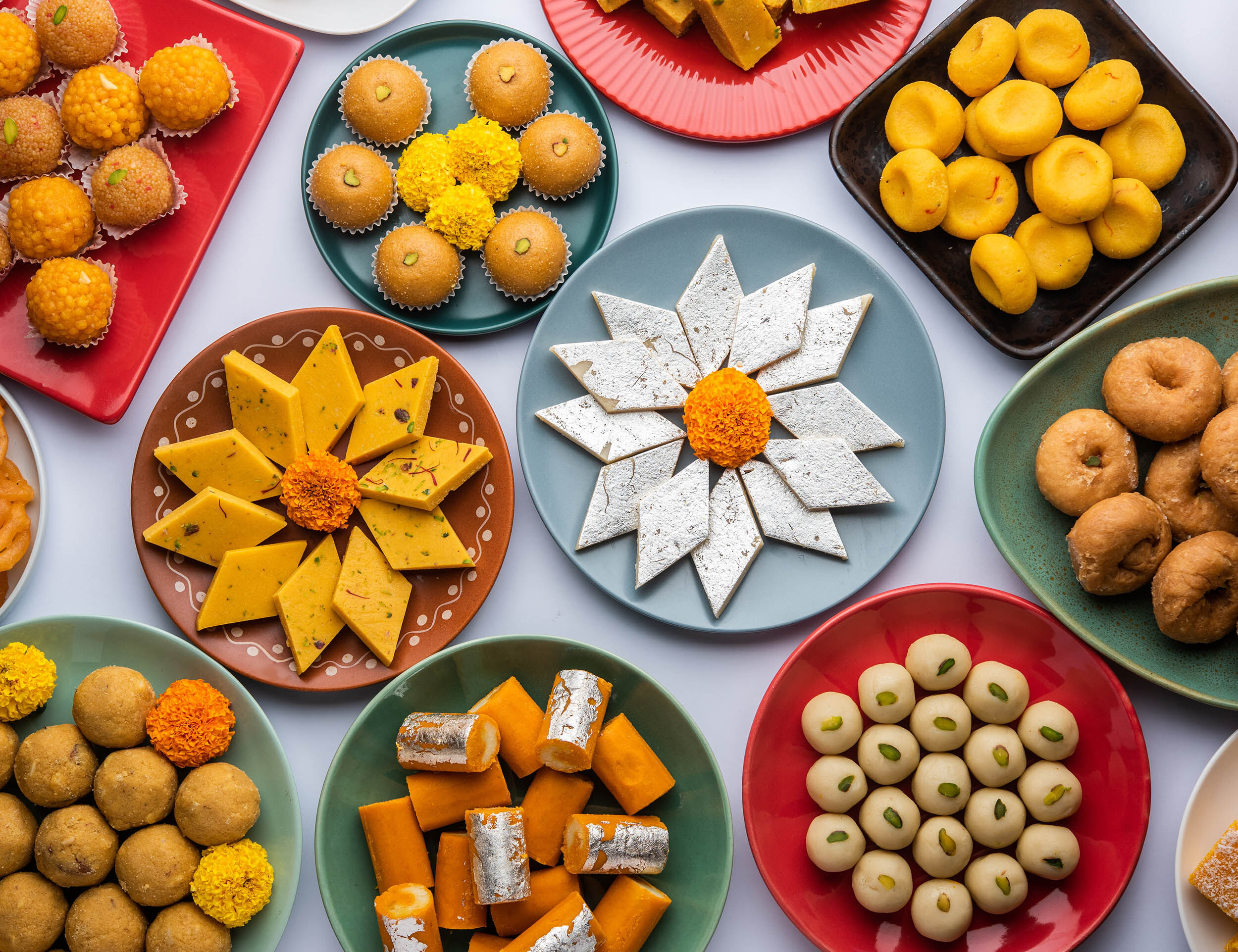Traditional Bengali sweets artfully arranged for a wedding celebration, reflecting the colorful and lively Bengali culture.